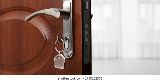 Closeup View Of Door With Key Open Into Empty Room