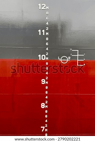 Close-up view of draft marks located at the midship section of a newly built commercial vessel. The image shows the ship’s hull with visible draft scale and waterline markings used for determining vessel draft, loading condition, stability calculations, and maritime inspections. Ideal for shipping, marine engineering, naval architecture, and transportation concepts