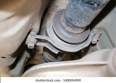 Closeup view of the dusty outboard bearing of the propeller shaft located at the bottom of the car. Intermediate support for propellershaft - Shutterstock ID 1400054909