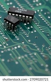 Close-up view of electronic components on a green circuit board with intricate details of connections