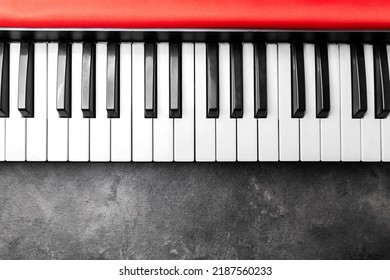 Closeup view of an electronic piano keyboard with black background