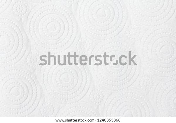 Closeup view of embossed surface texture of new\
white paper towel tissue from roll in heart-shape, dots, dashed and\
circular pattern. For wallpaper, backdrop and background with copy\
space