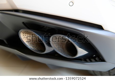 Closeup view of exhaust pipes of white super car