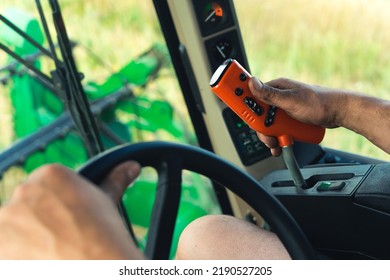 Closeup View Of Farmer's Hands Driving Combine Harvester, Tractor Operating Controlling Machinery. High Quality Photo