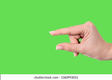 Closeup view of female hand forming gesture Little bit. Isolated on bright green chroma key background. Horizontal color photography. - Powered by Shutterstock