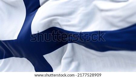 Close-up view of Finland national flag waving in the wind. Scandinavian country located in northern Europe
