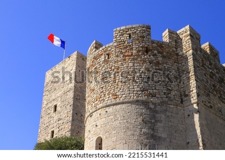 A close-up view at the Fortress with the french national flag in the old town of Cannes - France