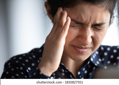 Closeup View Frown Face Of Indian Woman Feeling Strong Headache Touch Temple To Reduce Severe Pain, Suffering From Panic Attack In Office, Migraine Overworked Person Or Hangover Alcohol Abuse Concept