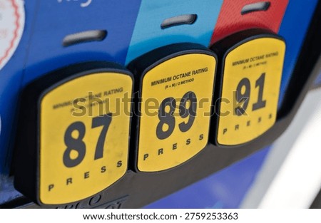 Close-up view of gasoline pump octane selection buttons labeled 87, 89, and 91 at a fuel station dispenser in Corona, California. The image represents vehicle refueling choices, transportation energy options, and everyday automotive infrastructure in Southern California.