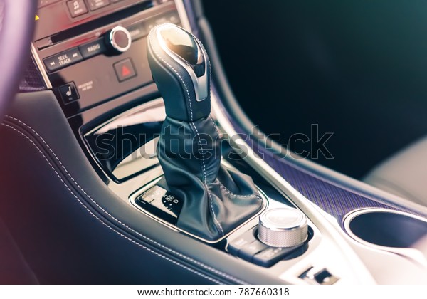 Closeup view of the gear stick with multimedia\
console in a luxury sport\
car