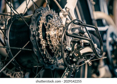 Close-up view of gears and derailleur on an electric bicycle including the hub that contains the motor - Powered by Shutterstock