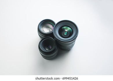 close-up view of a group of camera lenses on a white surface - Shutterstock ID 699451426