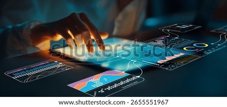 A close-up view of a hand interacting with a digital tablet displaying various data visualizations, ideal for exploring business analytics and technology.