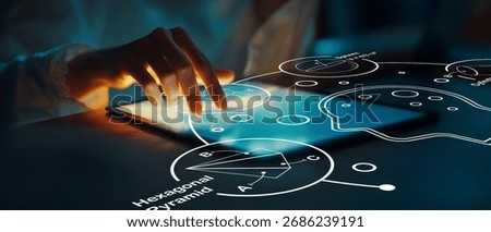 A close-up view of a hand interacting with a digital tablet displaying interactive geometric shapes and data visuals, showcasing the fusion of technology and creativity.
