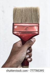 Closeup View Of Hands Holding A Paint Brush