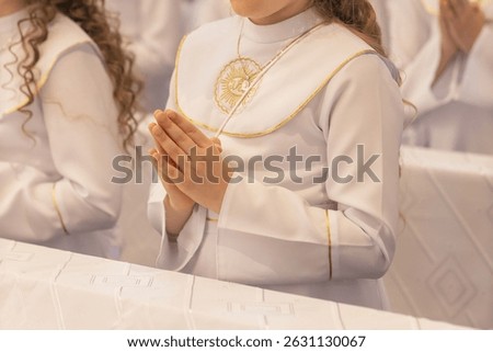 Close-up view of a child’s hands joined in prayer during First Holy Communion. A symbolic moment of faith, innocence, and religious devotion. Gifts and spiritual meaning combined.