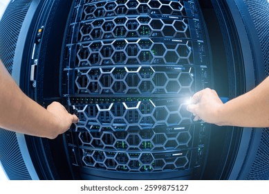 A close-up view of hands working on a server rack in a modern data center. The image showcases technology and maintenance efforts in a high-performance computing environment.
