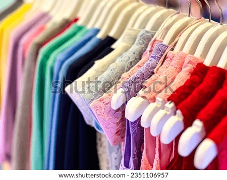 A close-up view of the hangers of various types of women's clothing.
