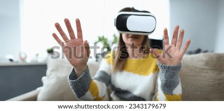 Close-up view of happy young woman using virtual reality headset