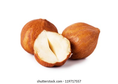 Closeup view of hazelnuts over white background