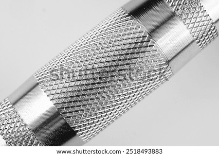 A close-up view highlighting the intricate patterns on a metal tool's surface.