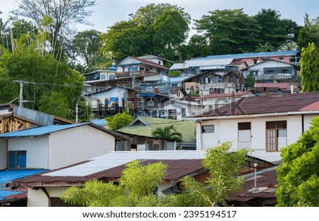 a close-up view of houses stacked against the hill.