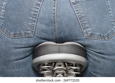 Close-up view of a human butt on a bicycle seat, depicting bicycling, weight issues, physical exercise.  No actual humans were inside of the jeans, so no model release needed