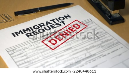 A closeup view of an immigration application getting denied. Data on form is fictional.	