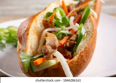 A Closeup View Inside A Chicken Banh Mi Sandwich.