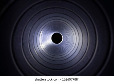 Closeup View From Inside The Galvanized Steel Air Duct On The Exhaust Fan In The Background Light, The Front And Back Background Is Blurred With A Bokeh Effect