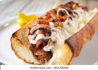 A Closeup View Inside A Grilled Mushroom And Steak Hoagie Sandwich.