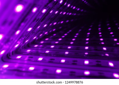 Closeup view inside of a light mirror in purple