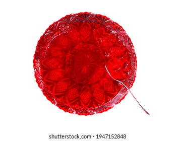 Closeup view of jelly food plate, editable jelly food plate with metal spoon, top view of fresh red jelly plate in cut white transparent background with decoratively designed transparent glass plate 
