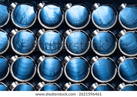Close-up view of the launch tubes of a multiple rocket launcher system. The symmetrical pattern, metallic textures