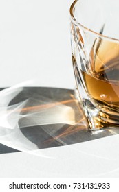 close-up view of luxury cognac in glass on white 
