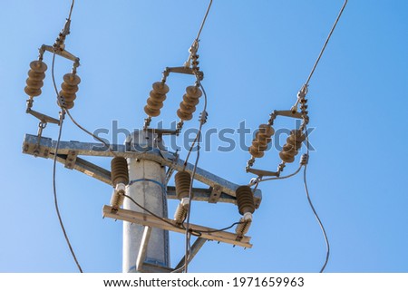 closeup view of mains power line junction with insulator
