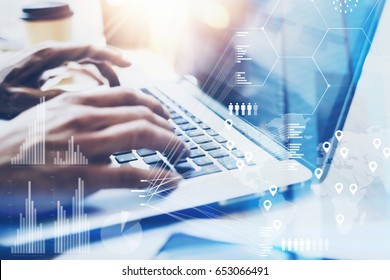 Closeup view of Male hand typing on laptop keyboard.Businessman working at office on modern notebook.Concept of digital diagram,graph interfaces,virtual screen,connections icon.Blurred