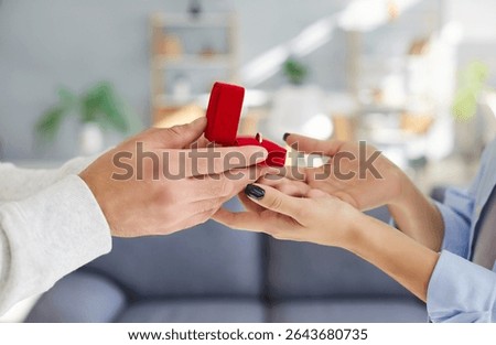 Close-up view of a man hands proposing to a woman, presenting a romantic gift ring. Relationship in future family, couple love, romance, affection and the proposal leading to marriage.