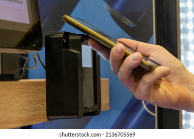 Close-up View Of Man Paying For Purchase At Micro Market (automated Unmanned Store) Using Smart Phone. Contactless Payment Theme.