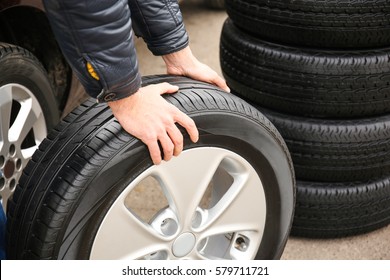 Closeup view of man rolling wheel outdoors - Powered by Shutterstock