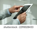Closeup view of man using new tablet indoors