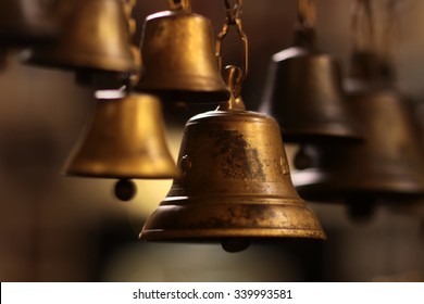 Closeup view of many beautiful old fashioned golden christmas bells hanging as new year toys, horizontal picture - Shutterstock ID 339993581