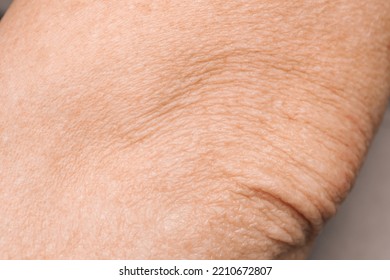 Closeup view of mature person with clean skin on elbow - Shutterstock ID 2210672807