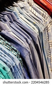 Close-up View Of Men Shirts Hanging On Hangers In Shop Display