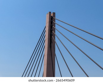 Close-up view of a modern cable-stayed bridge pylon with steel cables