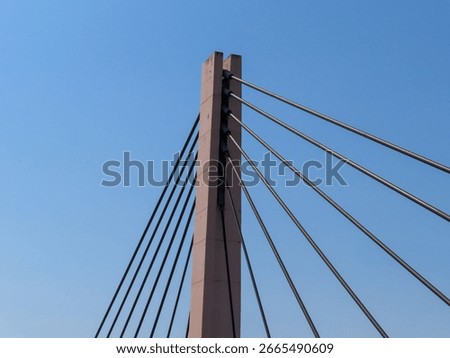Close-up view of a modern cable-stayed bridge pylon with steel cables