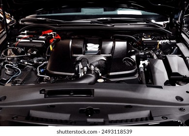 A close-up view of a modern car engine bay, showcasing various components including the engine block, battery, wiring, and air intake. Perfect for automotive and mechanical themes. - Powered by Shutterstock