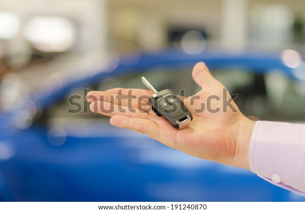 Closeup\
view of  modern car key on open male\
handbreadth