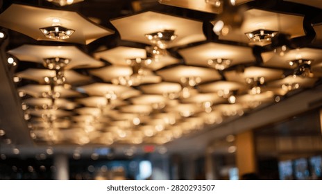 A close-up view of a modern ceiling with multiple hexagonal light fixtures emitting a warm, inviting glow.
