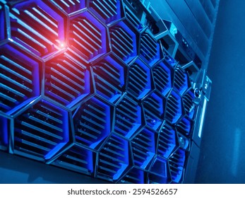 Close-up view of modern computer server hardware featuring a hexagonal pattern. The blue lighting highlights the intricate design and technology elements.